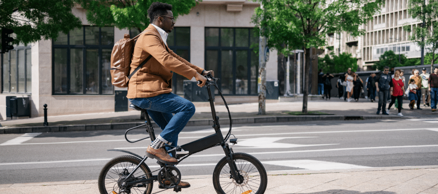 man riding e-bike in city